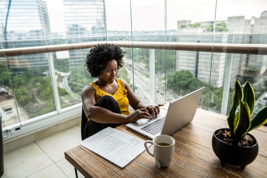 a person sitting at a table in front of a window