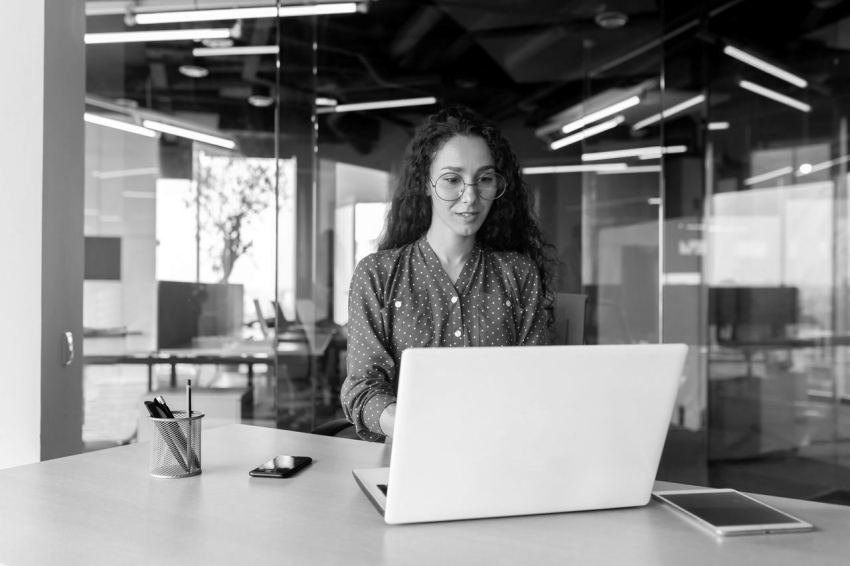 Woman sitting at table with laptop.