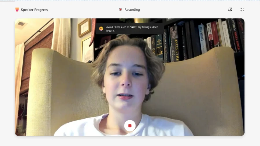 A student recording a Speaker Progress assignment with their laptop camera. A message on screen shows real-time, AI-powered feedback: Avoid fillers such as ‘um’. Try taking a deep breath.